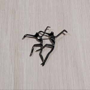 Two dancers brooch in dark metal